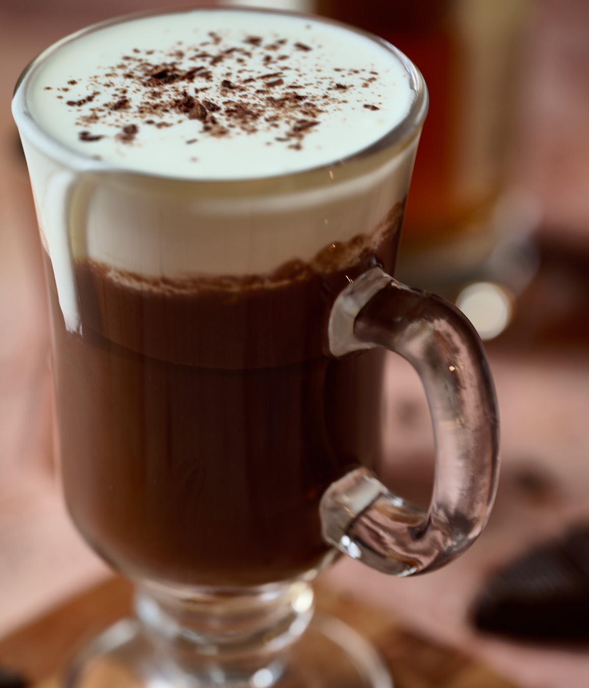 Close up of chocolate Irish coffee garnished with cocoa shavings.