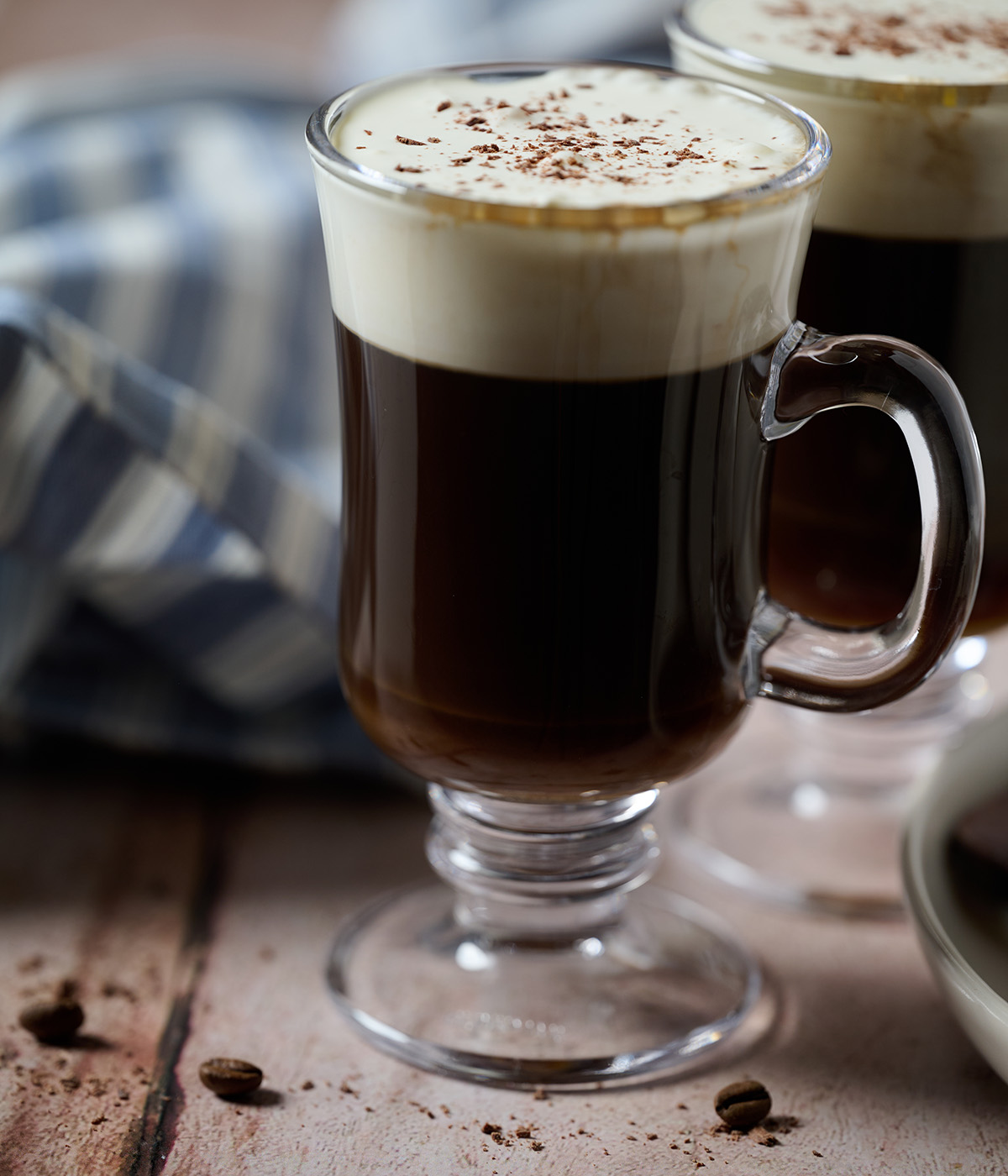 Two chocolate Irish coffees on a wooden table.