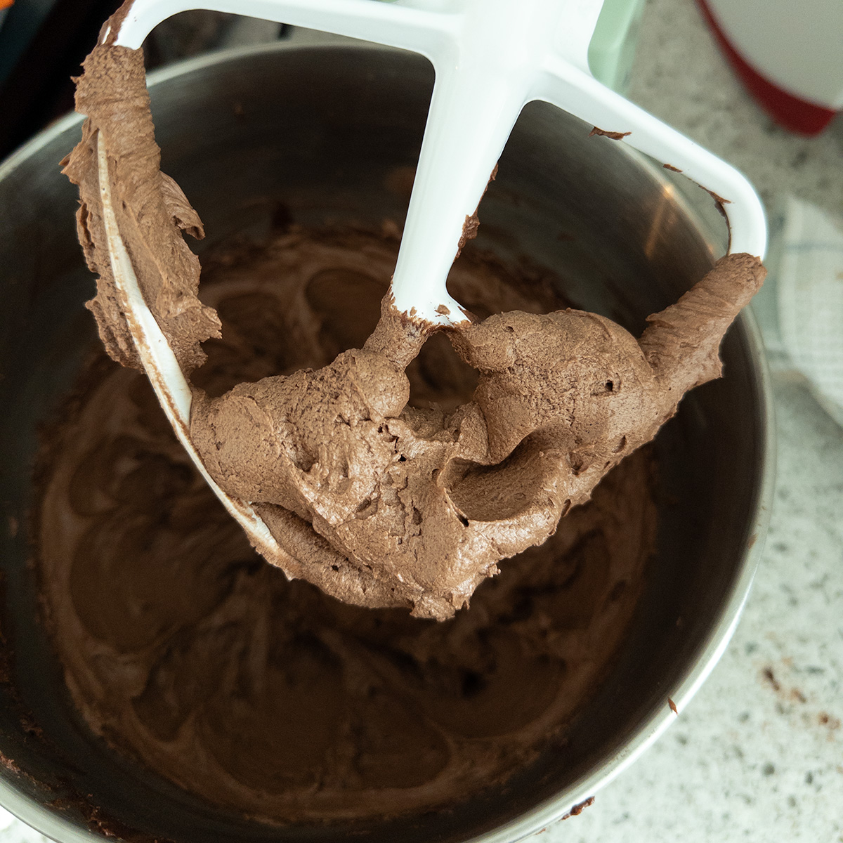 Chocolate buttercream frosting in a stand mixer.