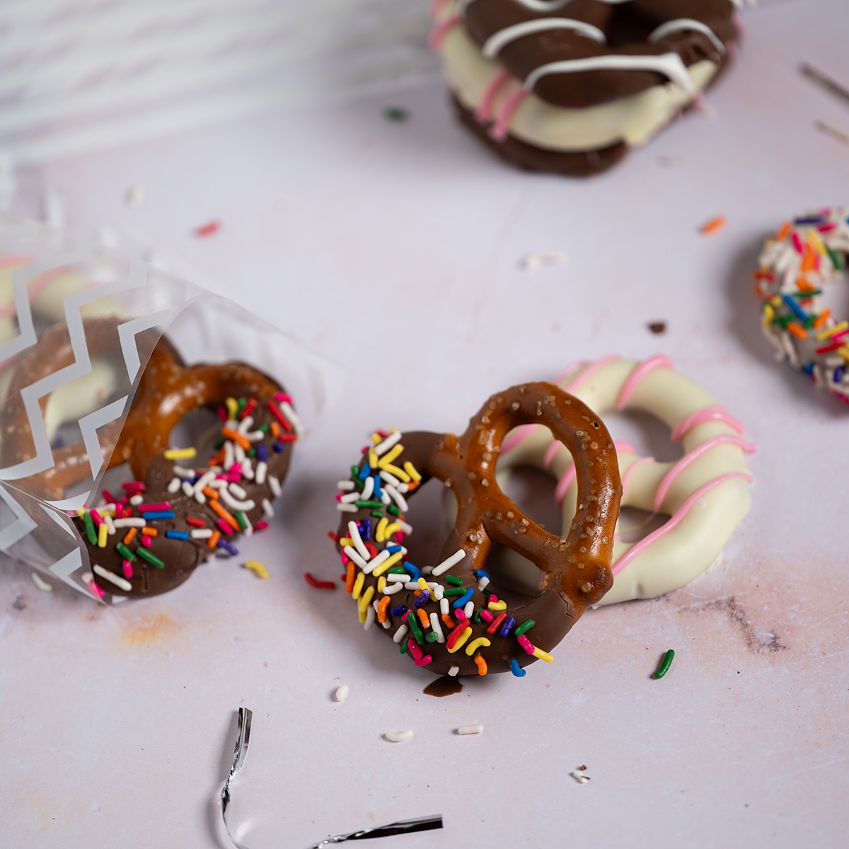 Gift-wrapping chocolate-covered pretzels.