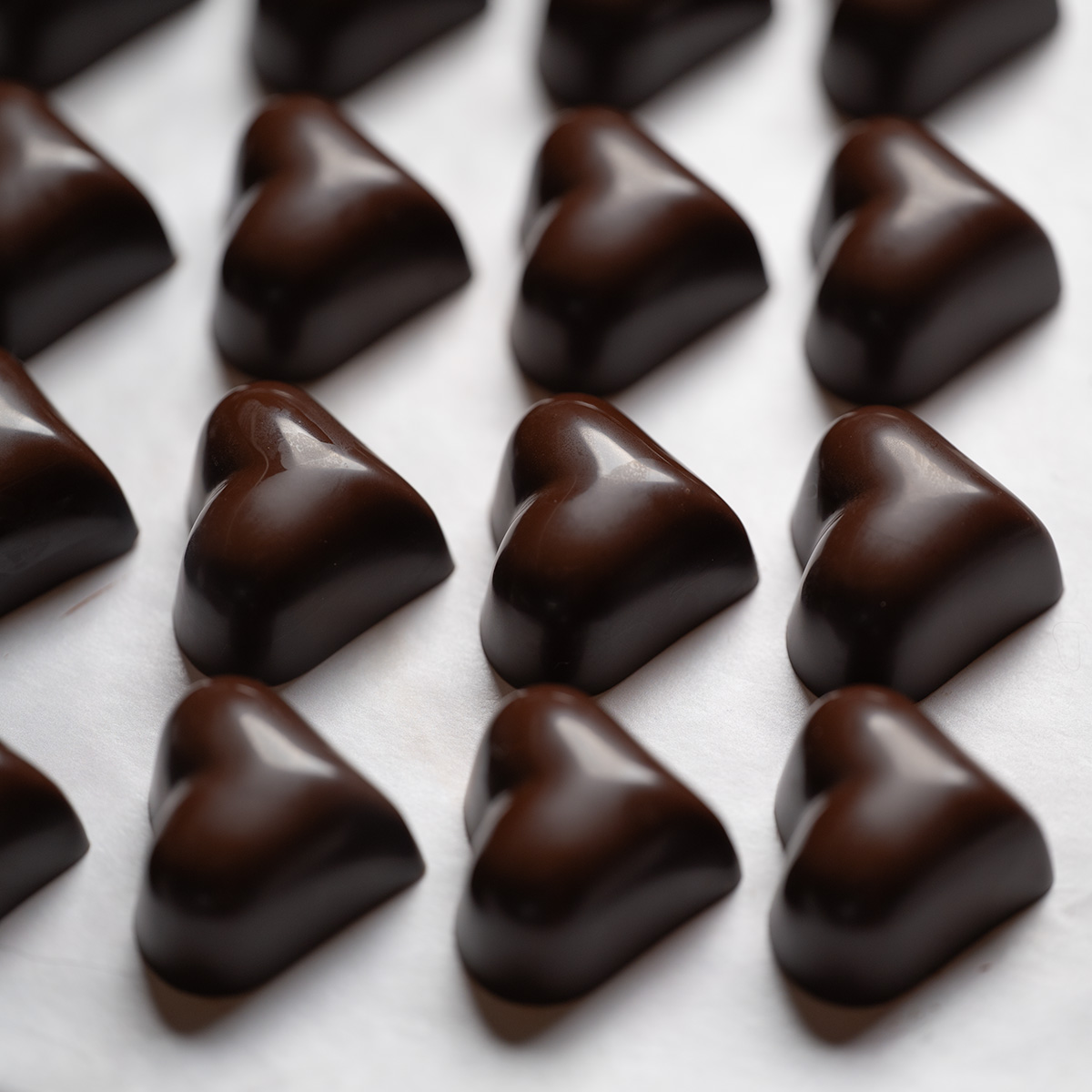 Rows of solid dark chocolate hearts.