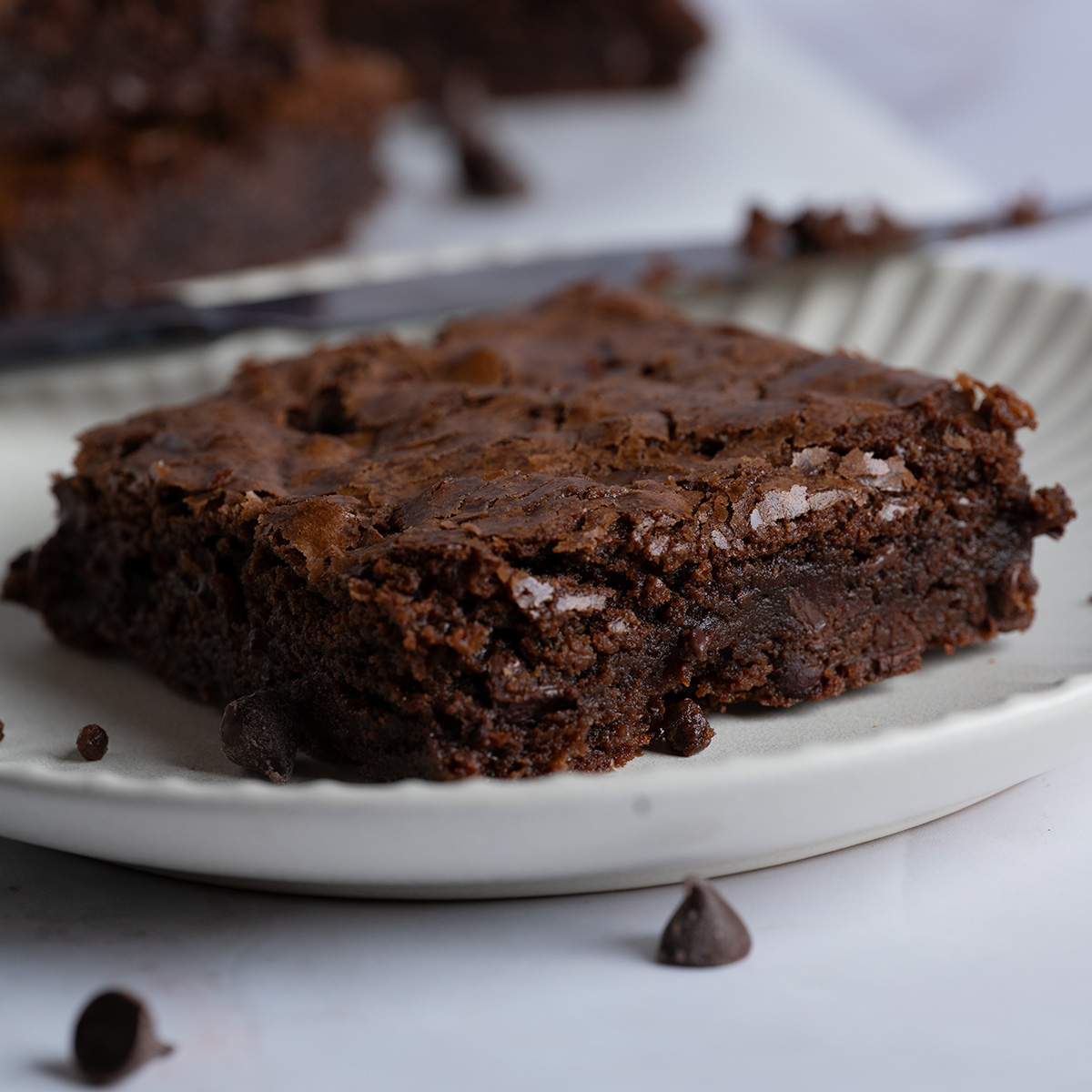 A gooey, fudgy chocolate brownie on a plate.