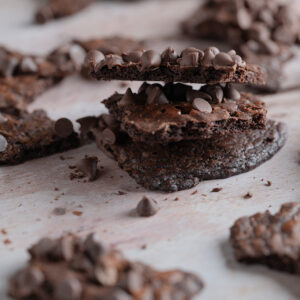Stacked pieces of triple chocolate brownie brittle.