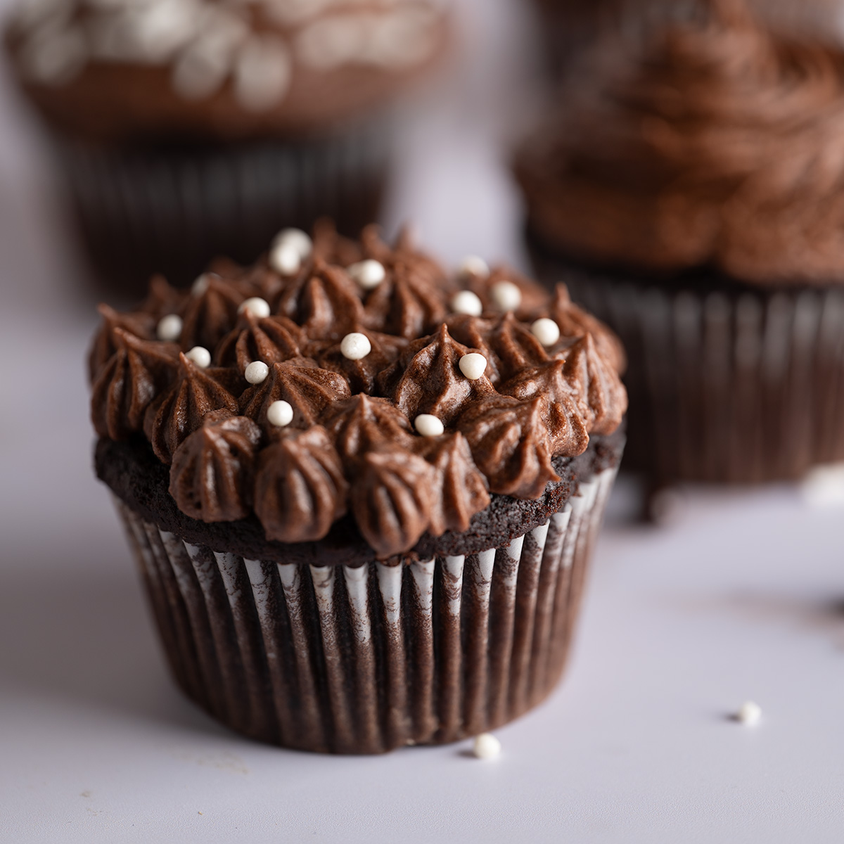 Star-shaped chocolate buttercream icing on a cupcake.