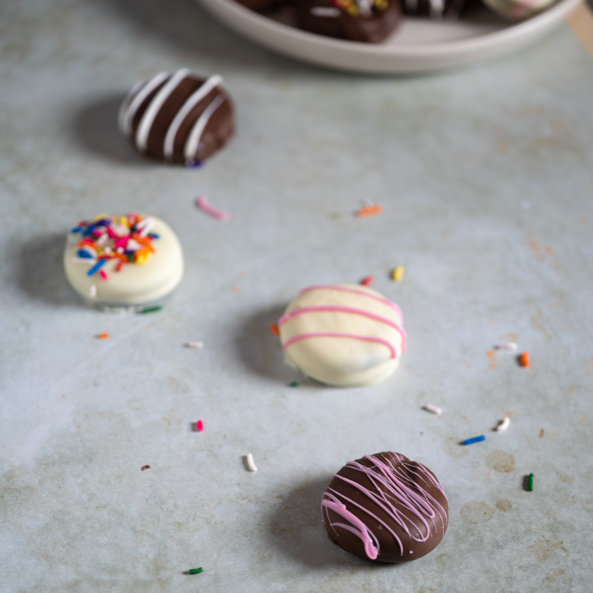 A trail of chocolate-covered Oreos leading to a plate.