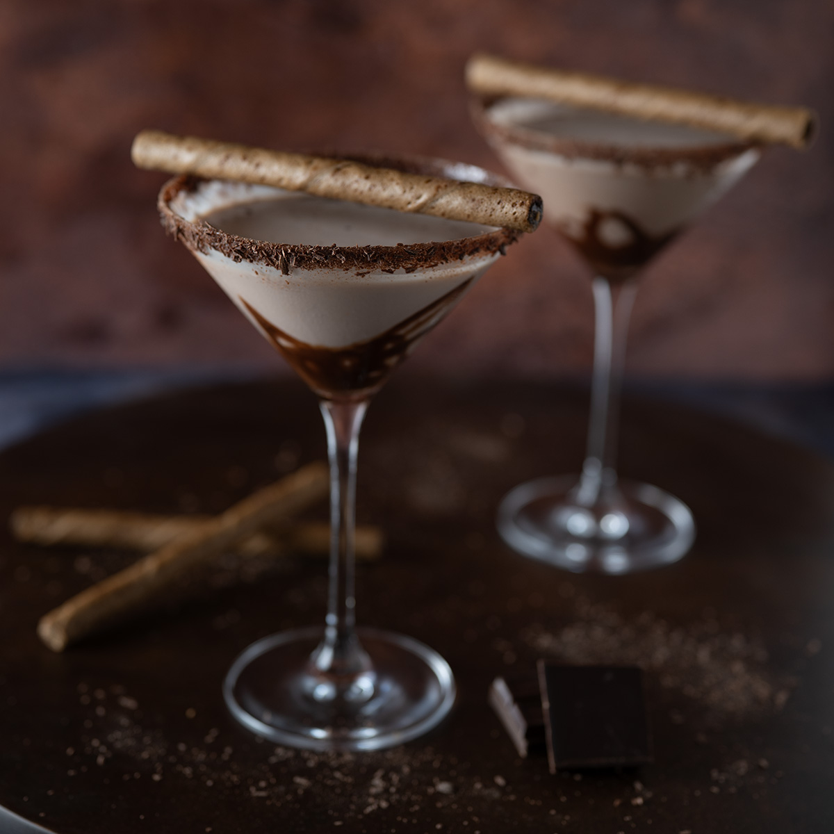 Two chocolate martinis with garnish.