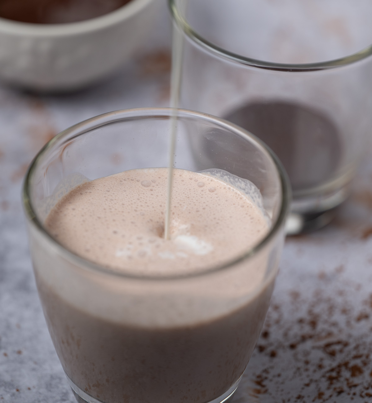 Chocolate milk being made with homemade chocolate syrup.