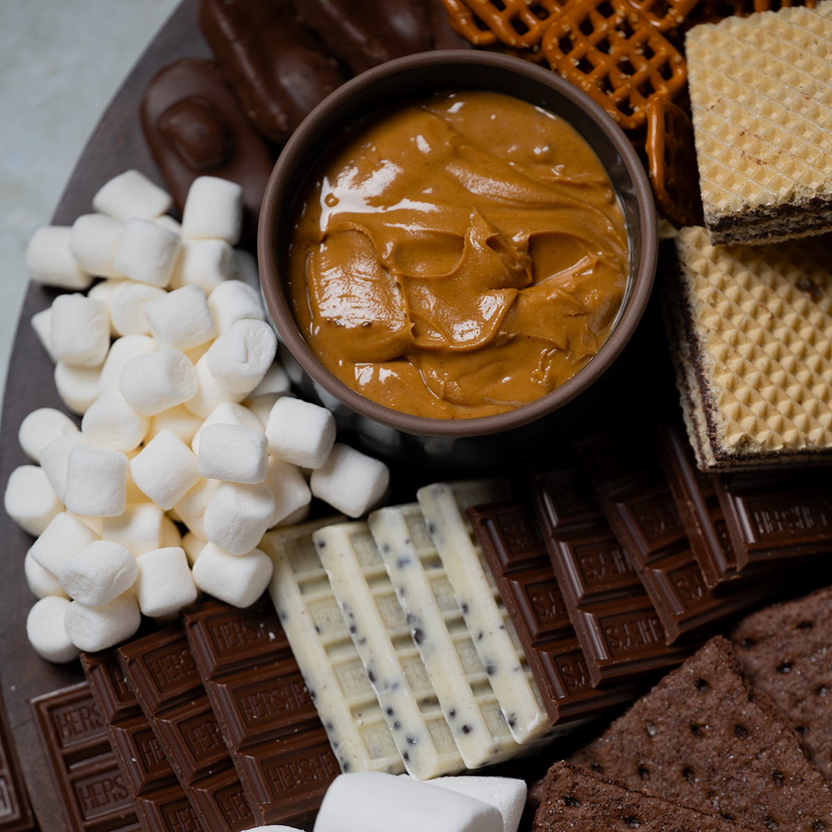 Peanut butter dip on a s'mores charcuterie board.