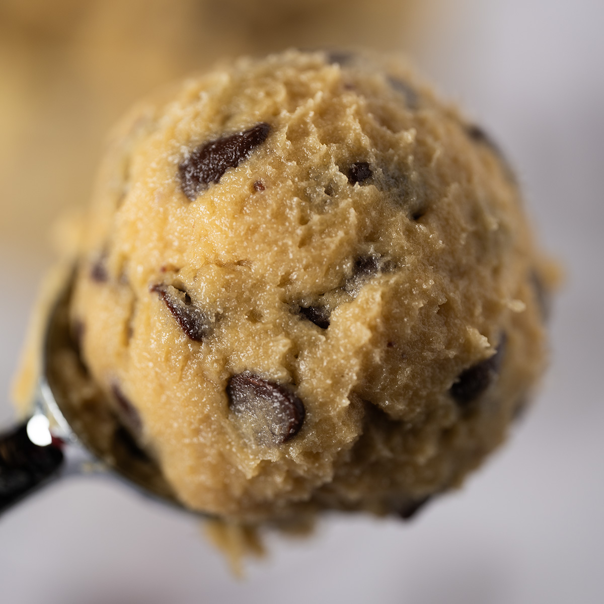 A macro shot of a scoop of edible cookie dough.