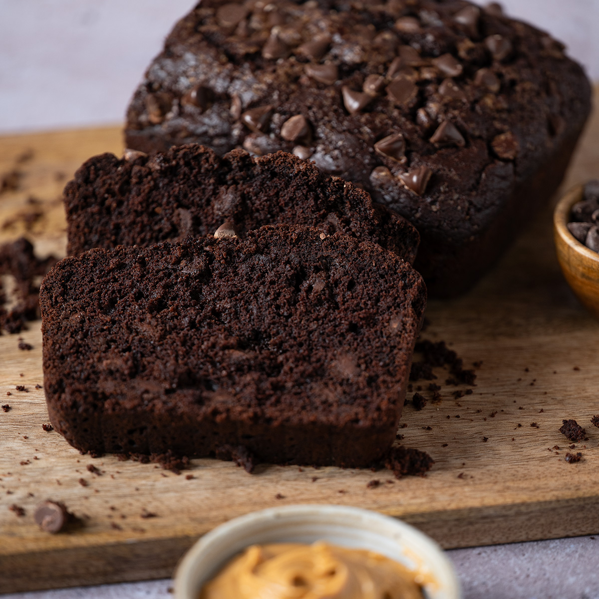 Slices of chocolate loaf cake served with peanut butter spread.