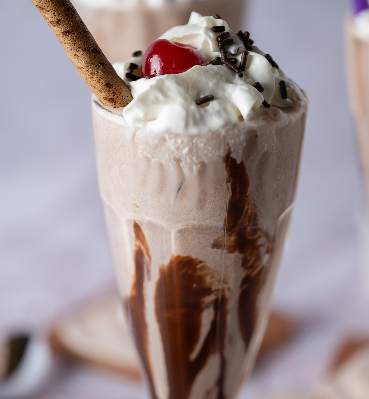 A thick chocolate milkshake with a chocolate Pirouette.