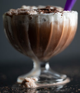 A dribble of frozen hot chocolate dripping down the side of the glass.