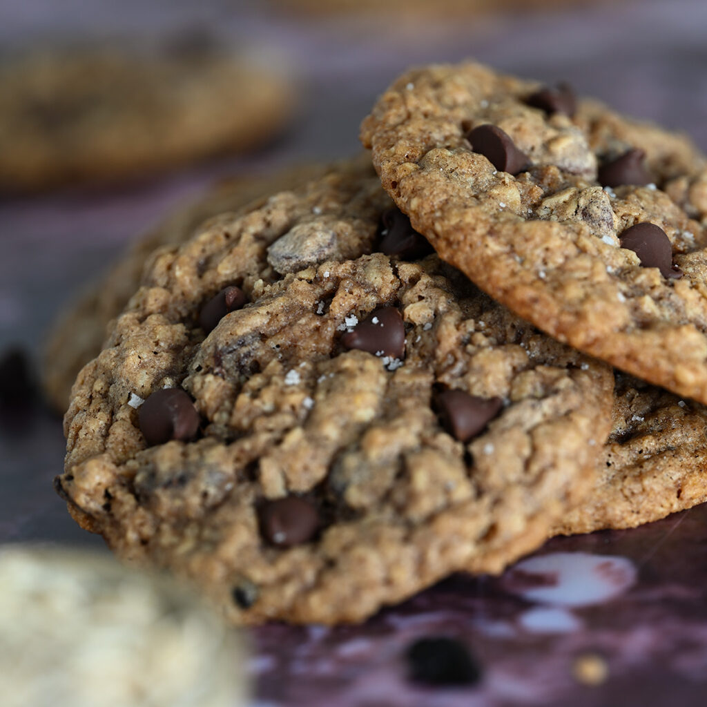 Finishing salt sprinkled over chocolate chip oatmeal raisin cookies.
