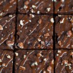 Cutting into a tray of freshly-baked turtle brownies.