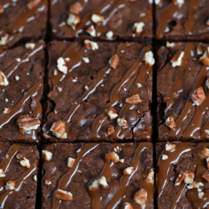 Cutting into a tray of freshly-baked turtle brownies.